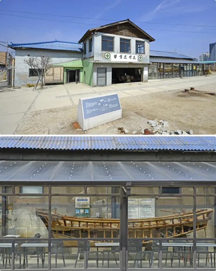 Modern seaside cafe with large glass windows and old ships on display.
