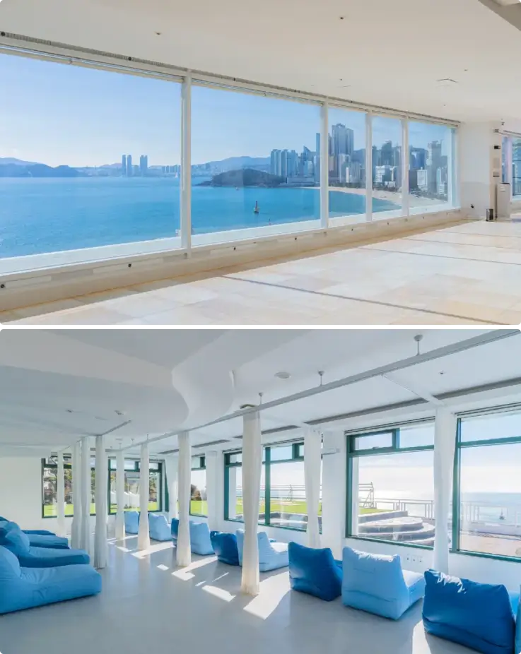 A bright and relaxing interior at HILL SPA with sweeping views of the sea through expansive glass windows.