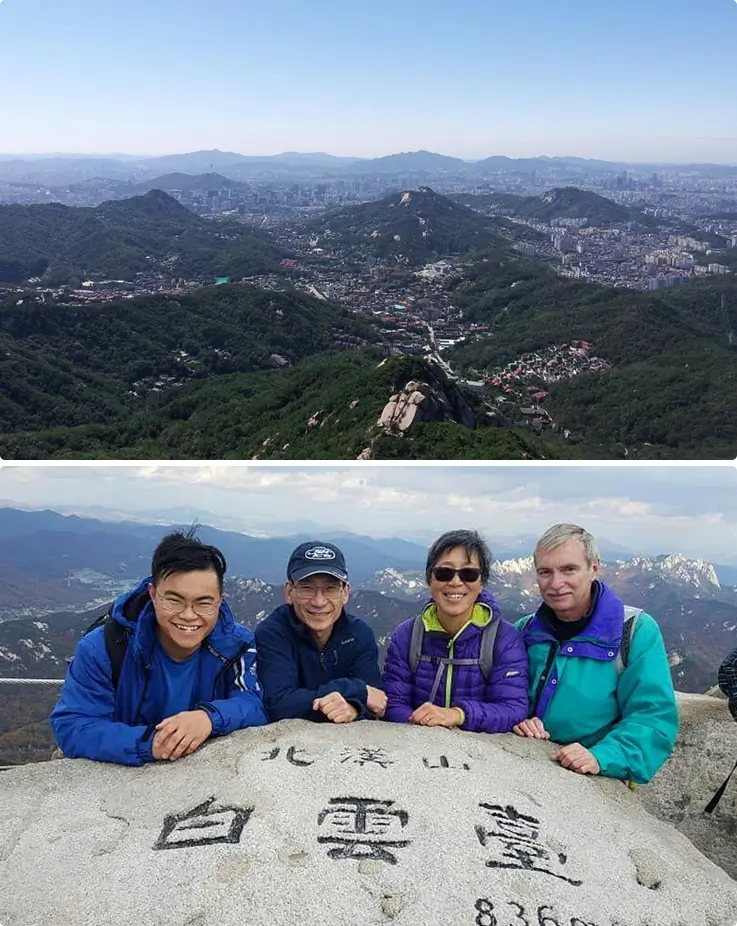 Hikers posing proudly on the peak of Bukhansan National Park.