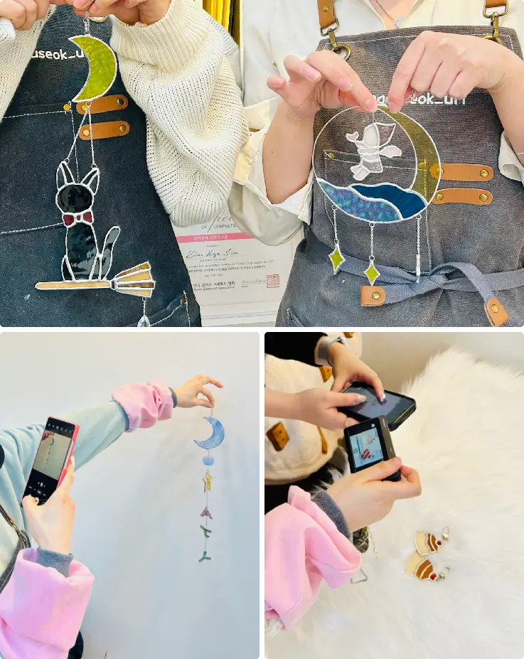 Participants holding their finished stained glass crafts in a Busan workshop