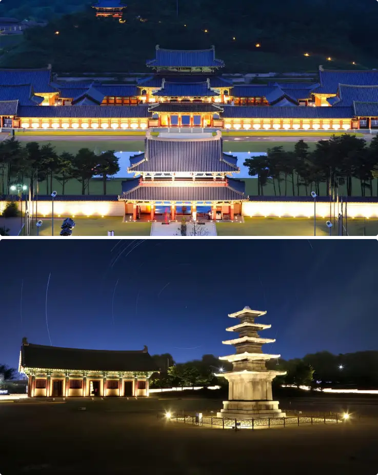 Baekje Cultural Land's royal palace and pagoda illuminated at night.
