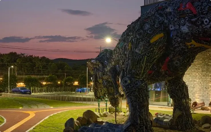 Life-sized robot and dinosaur junk art sculptures made from recycled metal at FE01 junk art gallery