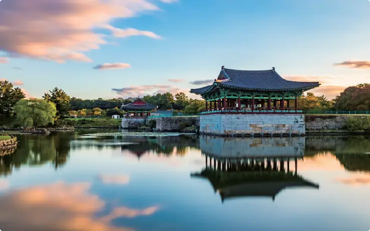 Historic palace buildings reflected in Wolji Pond in Gyeongju.