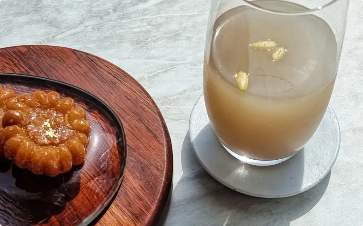 Participants enjoying Korean traditional desserts while crafting hanji and mother-of-pearl items.