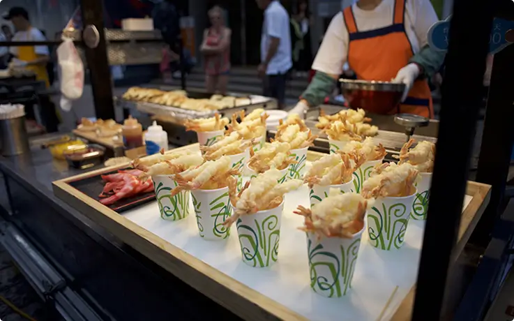 Street food stall selling fried shrimp at Namdaemun Market.