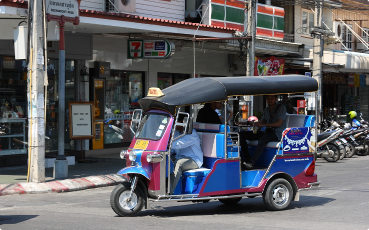 Tuk tuk driving along the streets of Hua Hin, Thailand.
