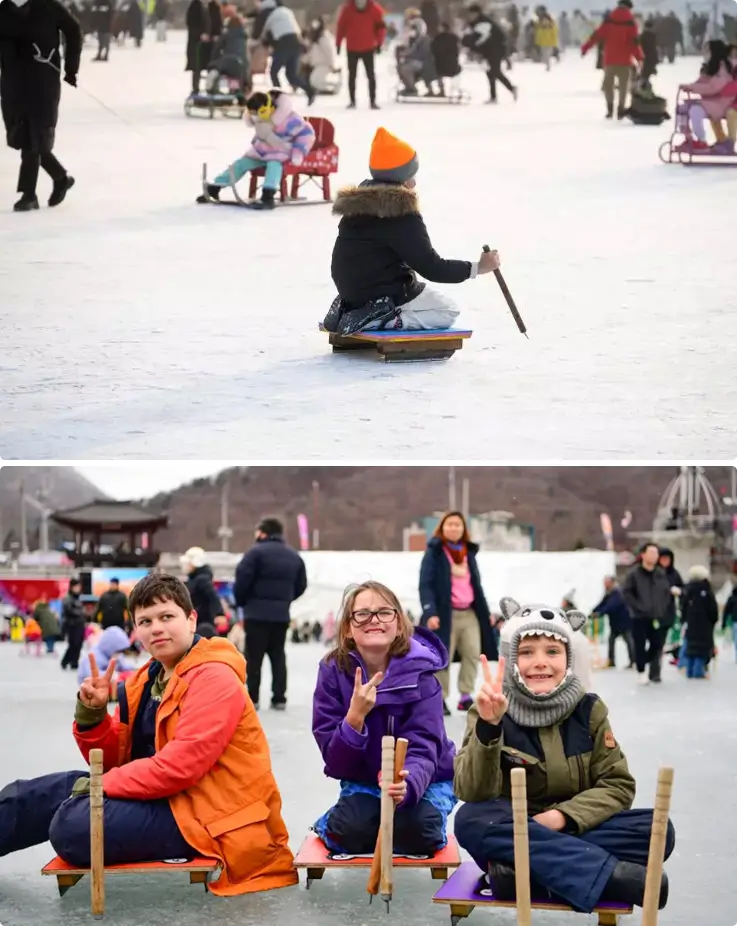 Children gliding above the frozen stream on ice sleds at the Hwacheon Sancheoneo Ice Festival in Korea.