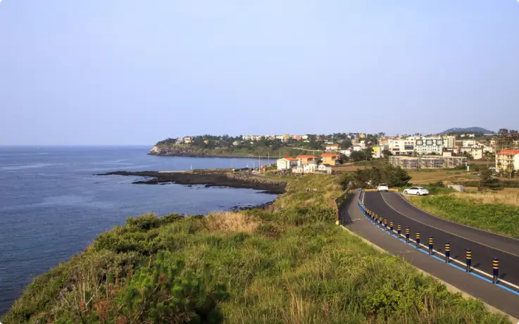 Scenic Aewol coastal road stretching along the sea.