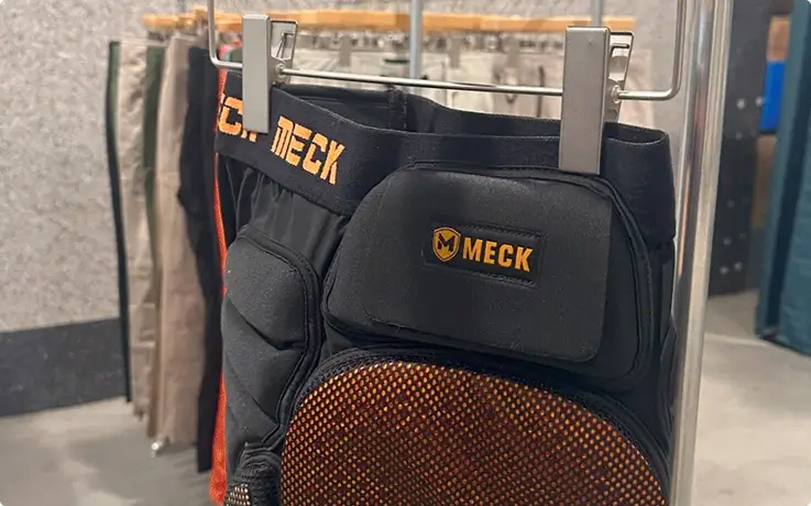 Hip protectors neatly displayed on a rack for selection.