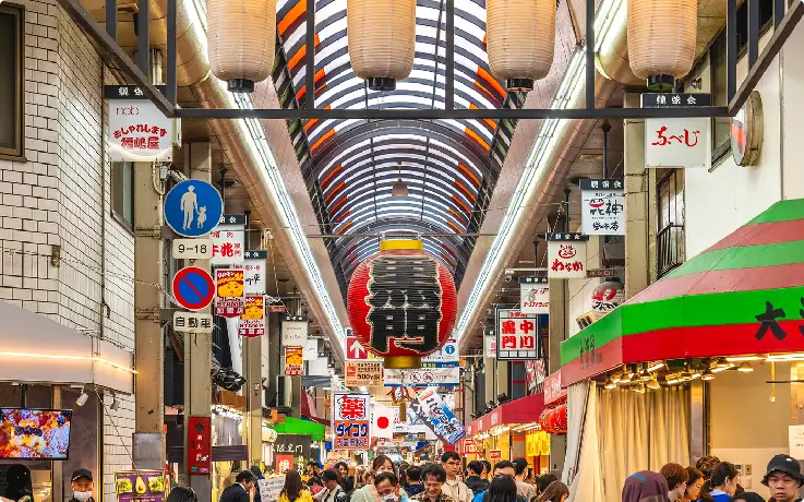 Neon signs and canal at Dotonbori in Osaka at night.