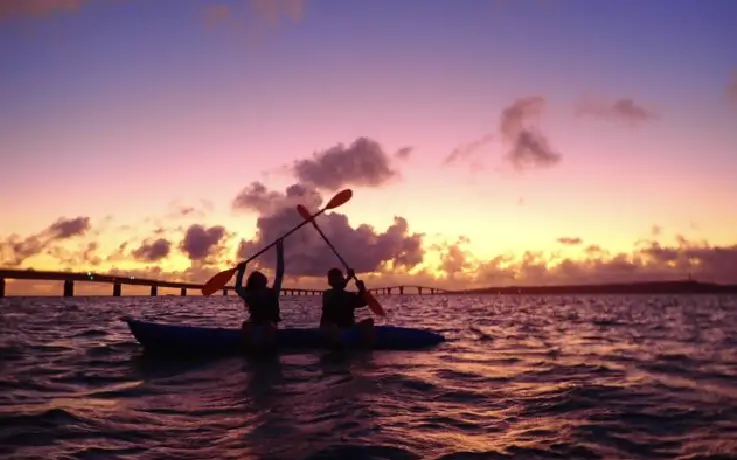 Kayaking across calm waters at sunset with ocean views in Miyakojima Island