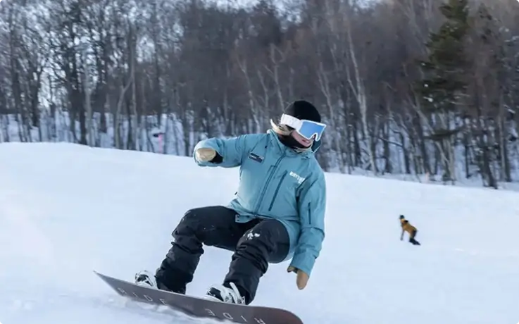 Snowboarding down a snowy slope in Niseko.
