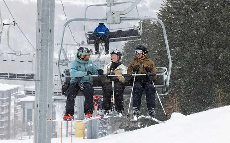 Skiers on a lift during a private ski lesson in Niseko.