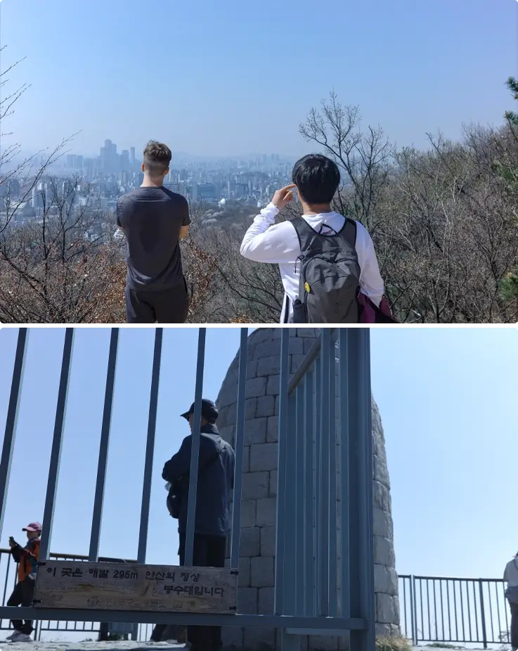 Visitors taking photos at Bongsudae peak at Ansan Mountain