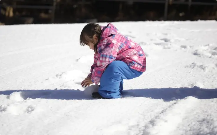 A child playing in the snow play area at Biwako Valley in Japan