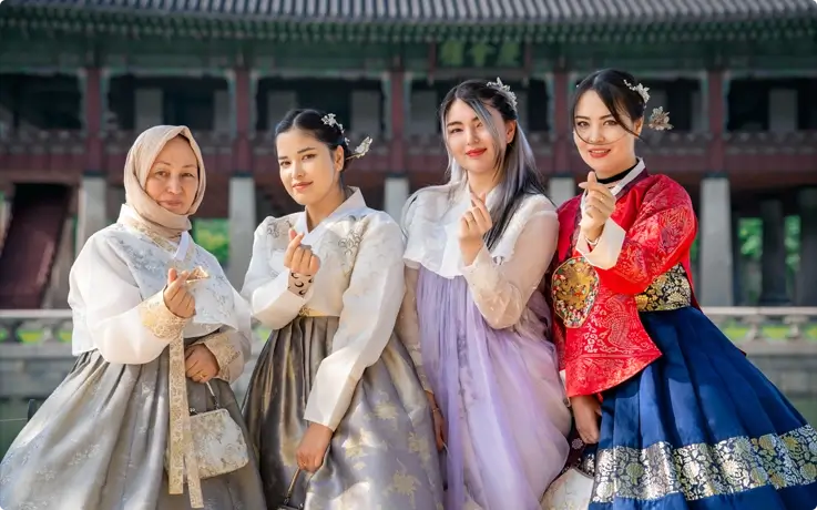 Visitors wearing Hanbok from Daehan Hanbok at Gyeongbokgung Palace including a matching hijab