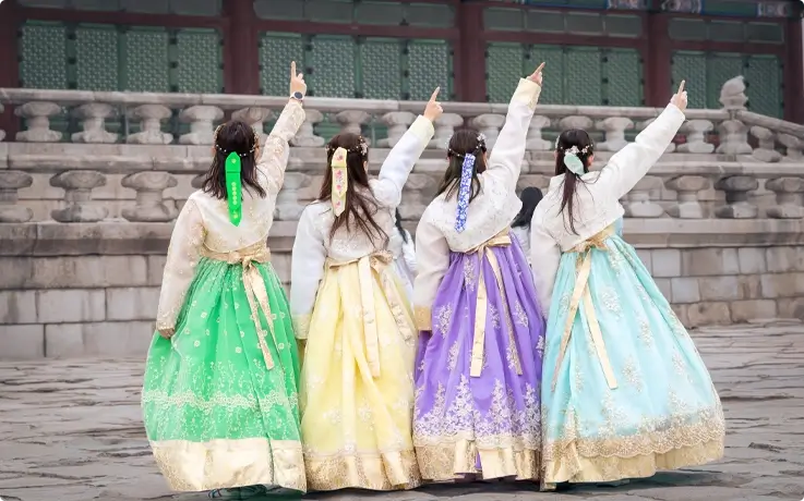 A group of friends wearing traditional or fusion Hanbok from Daehan Hanbok at Gyeongbokgung Palace