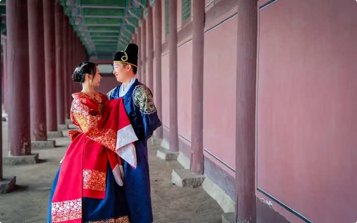 A couple wearing wedding Hanbok from Daehan Hanbok at Gyeongbokgung Palace