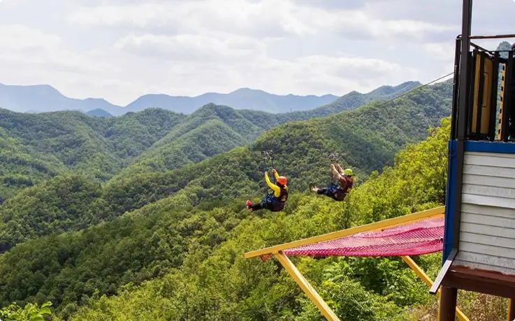 Visitors riding the zipline at Mancheonha Skywalk in Danyang