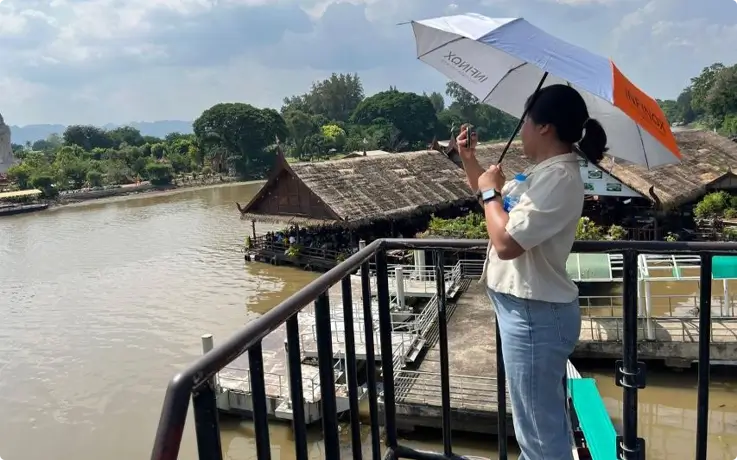 Visitor overlooking the River Kwai Bridge in Kanchanaburi