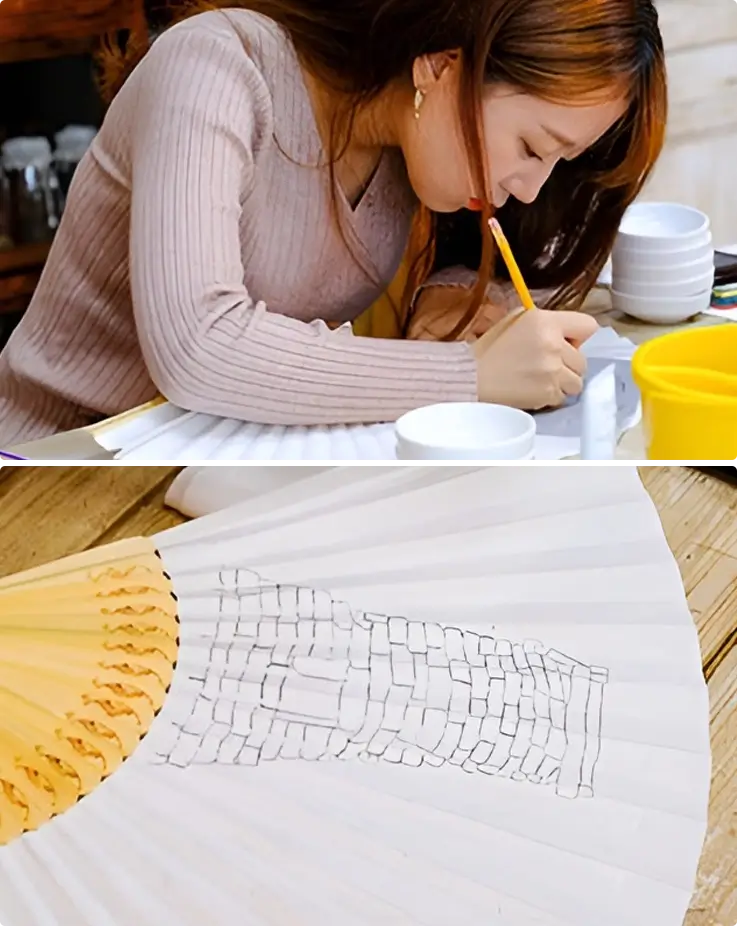 Visitor drawing illustrations on a fan in Gyeongju