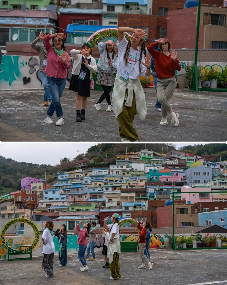 Visitors practicing dance moves at a dance class in Gamcheon Groove in Busan