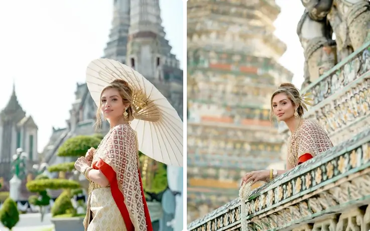Visitors taking photos in Thai costumes near Wat Arun