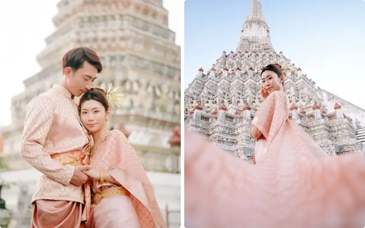Visitors taking photos in Thai costumes near Wat Arun