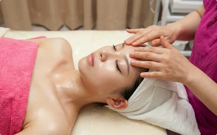 Visitor receiving facial massage at Hana Mud Spa in Myeongdong