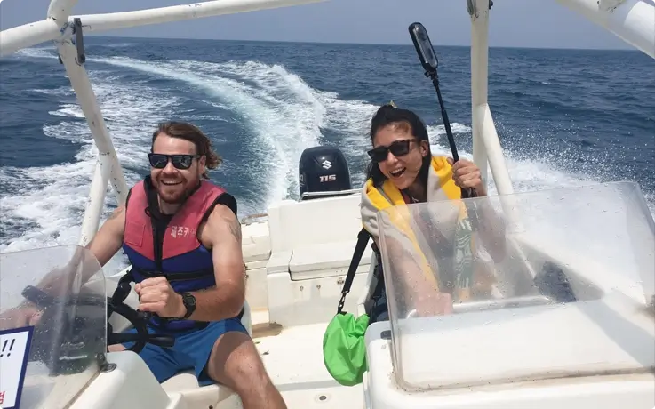 Visitors riding speedboat at Hado Beach in Jeju