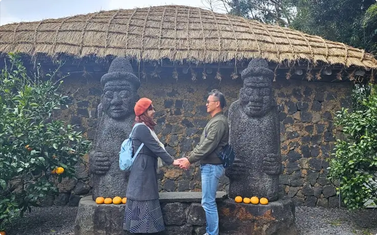 Visitors taking photos at Seongeup Folk Village in Jeju