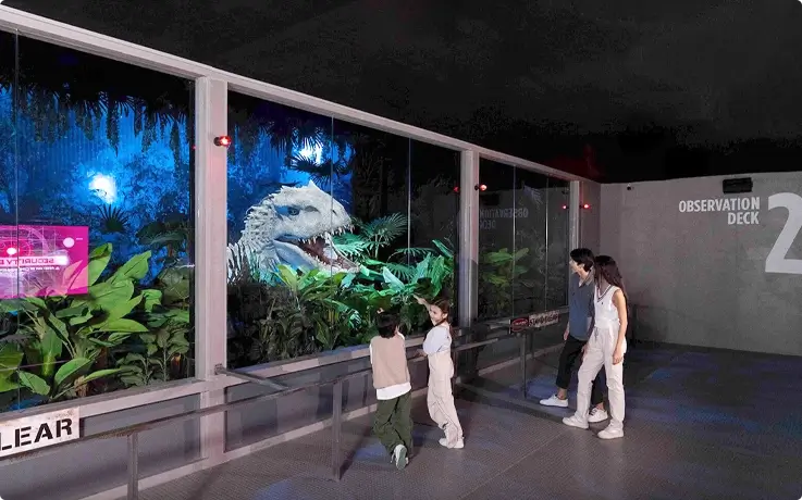 Visitors on the observation deck with the Indominus Rex appearing at Jurassic World: The Experience in Bangkok