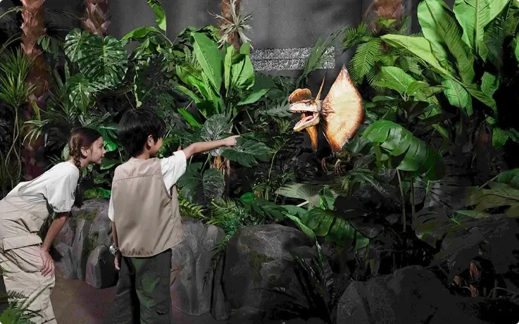 Visitors spotting a Carnotaurus at the Flight for Survival zone in Jurassic World: The Experience in Bangkok