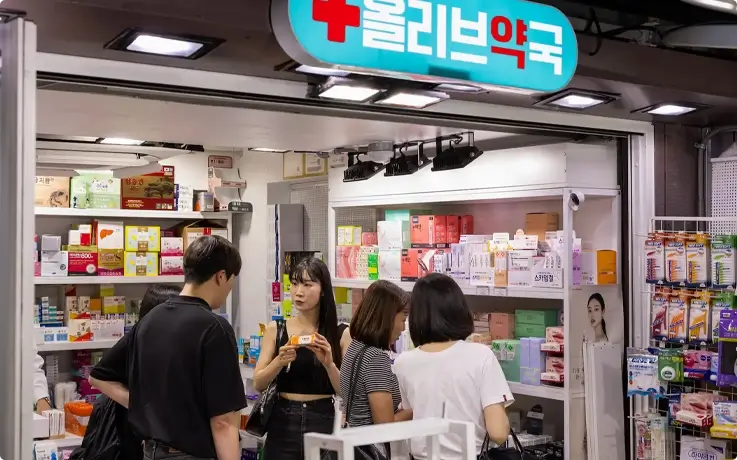 Guide explaining about the products at a pharmacy on the K-Beauty shopping tour in Myeongdong