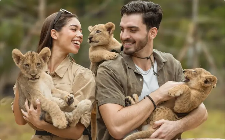Visitors taking photos with baby lions at Lion Land Phuket