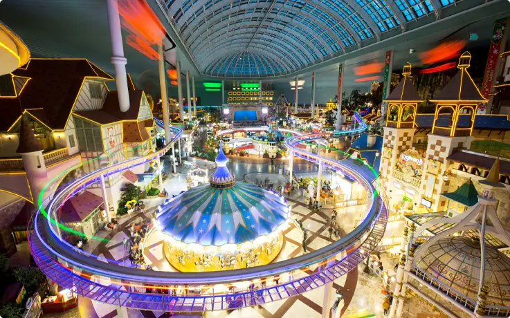 Indoor Adventure Zone at Lotte World with illuminated rides at night