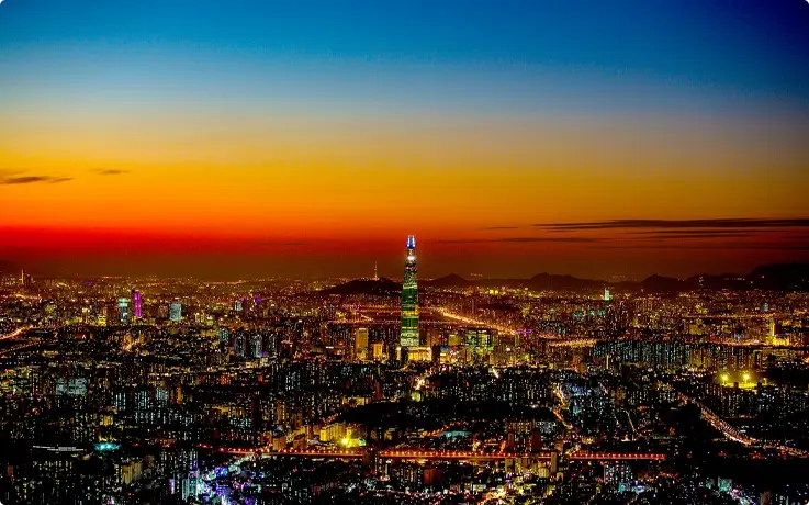 Lotte World Tower Seoul Sky shown with city scapes of Seoul during sunset