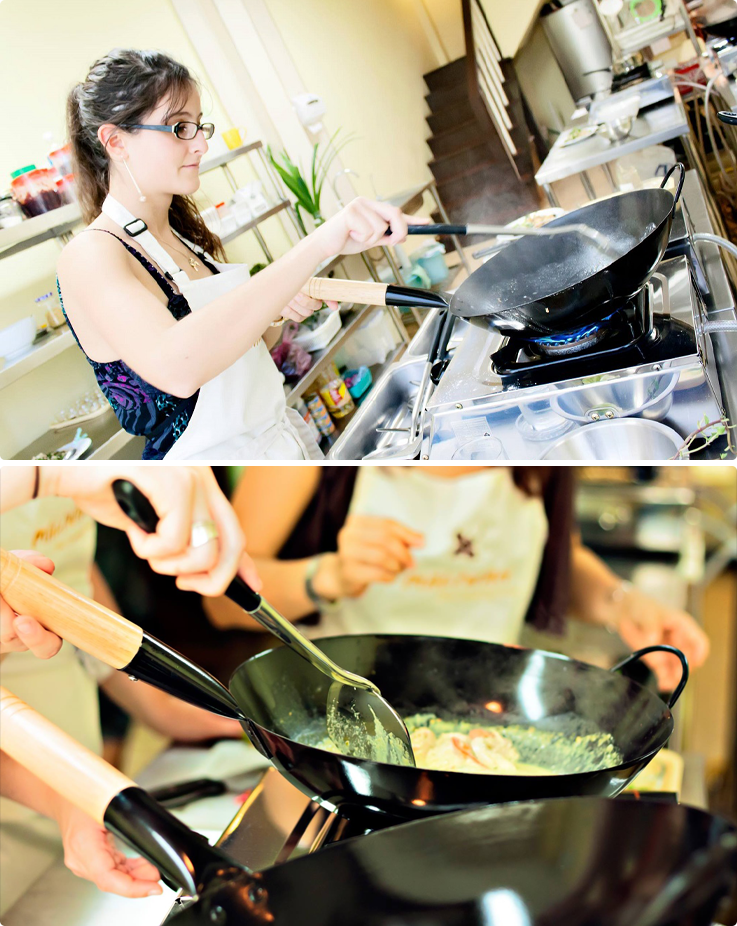 Visitors cooking at Maliwan Thai cooking class in Bangkok