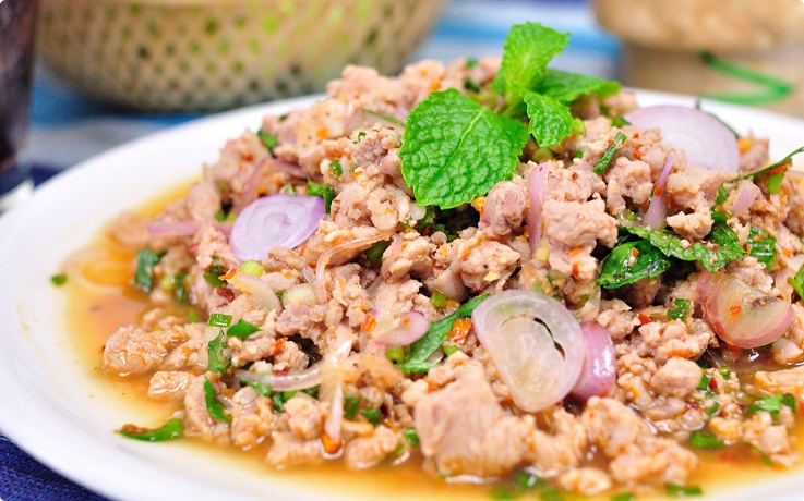 Spicy minced pork with mint leaves salad prepared during a class at Maliwan Thai Cooking Class in Bangkok