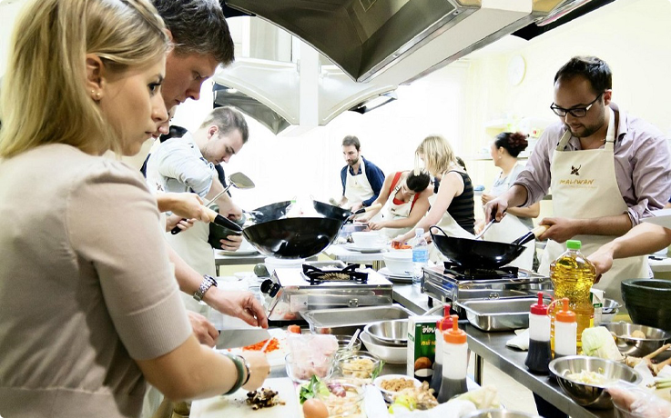 Visitors cooking at Maliwan Thai cooking class in Bangkok
