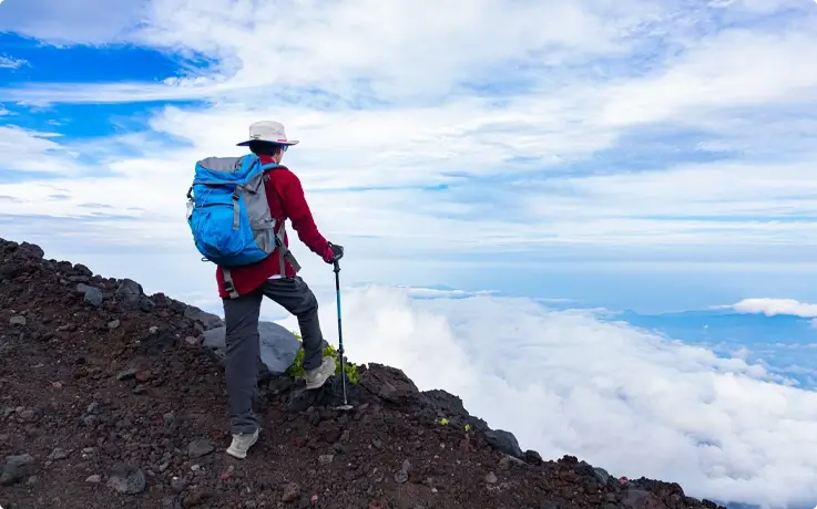 Visitor enjoying the mountain view while hiking Mt. Fuji