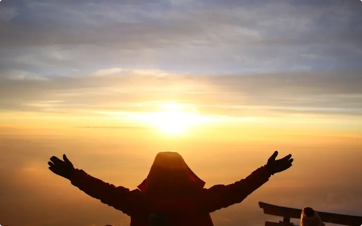 Visitor watching the sunrise from the Mt. Fuji summit