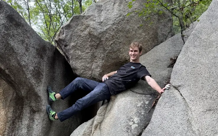 Visitors climbing a boulder in Anyang