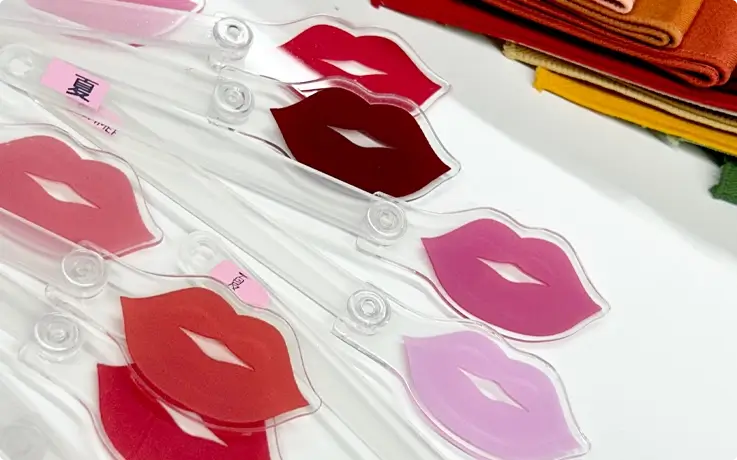 Plastic sticks with various lip shapes and shades displayed at a personal color analysis studio in Busan