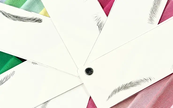 Paper chips showing different eyebrow shapes at a personal color analysis studio in Busan