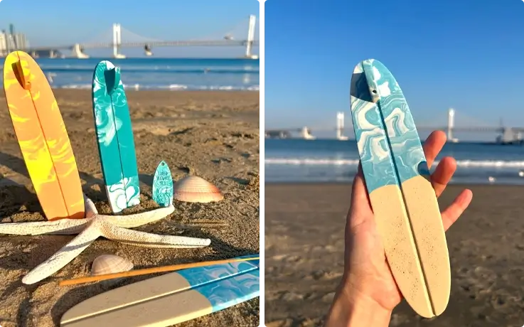 Surfboard incense holder made from eco-friendly resin, photographed with beach views at Gwangalli in Busan