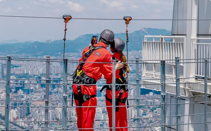 Visitors posing on the Sky Bridge at Lotte World Tower in Seoul