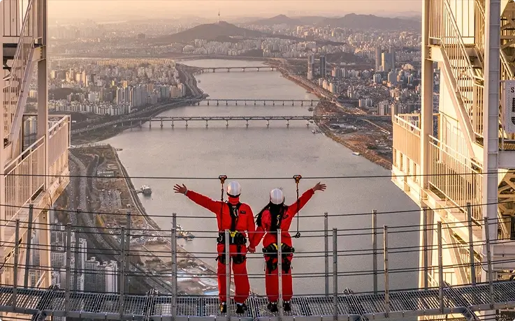 Visitors posing on the Sky Bridge at Lotte World Tower in Seoul