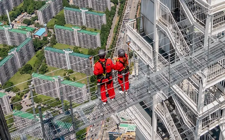 Visitors posing on the Sky Bridge at Lotte World Tower in Seoul