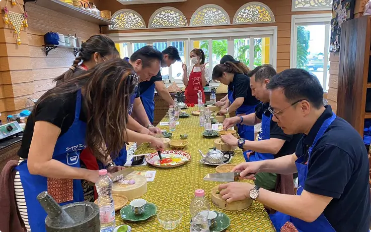 Visitors cooking at Sompong Cooking School in Bangkok